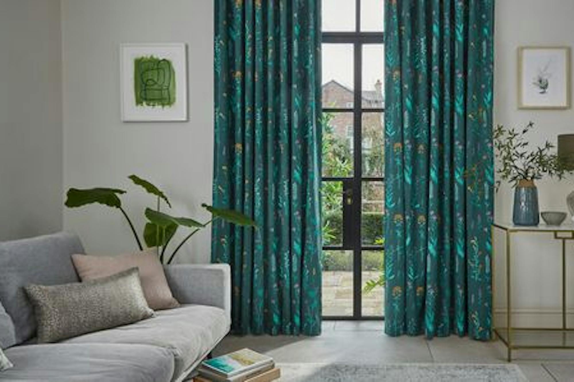 Teal patterned curtains covering large glass patio doors