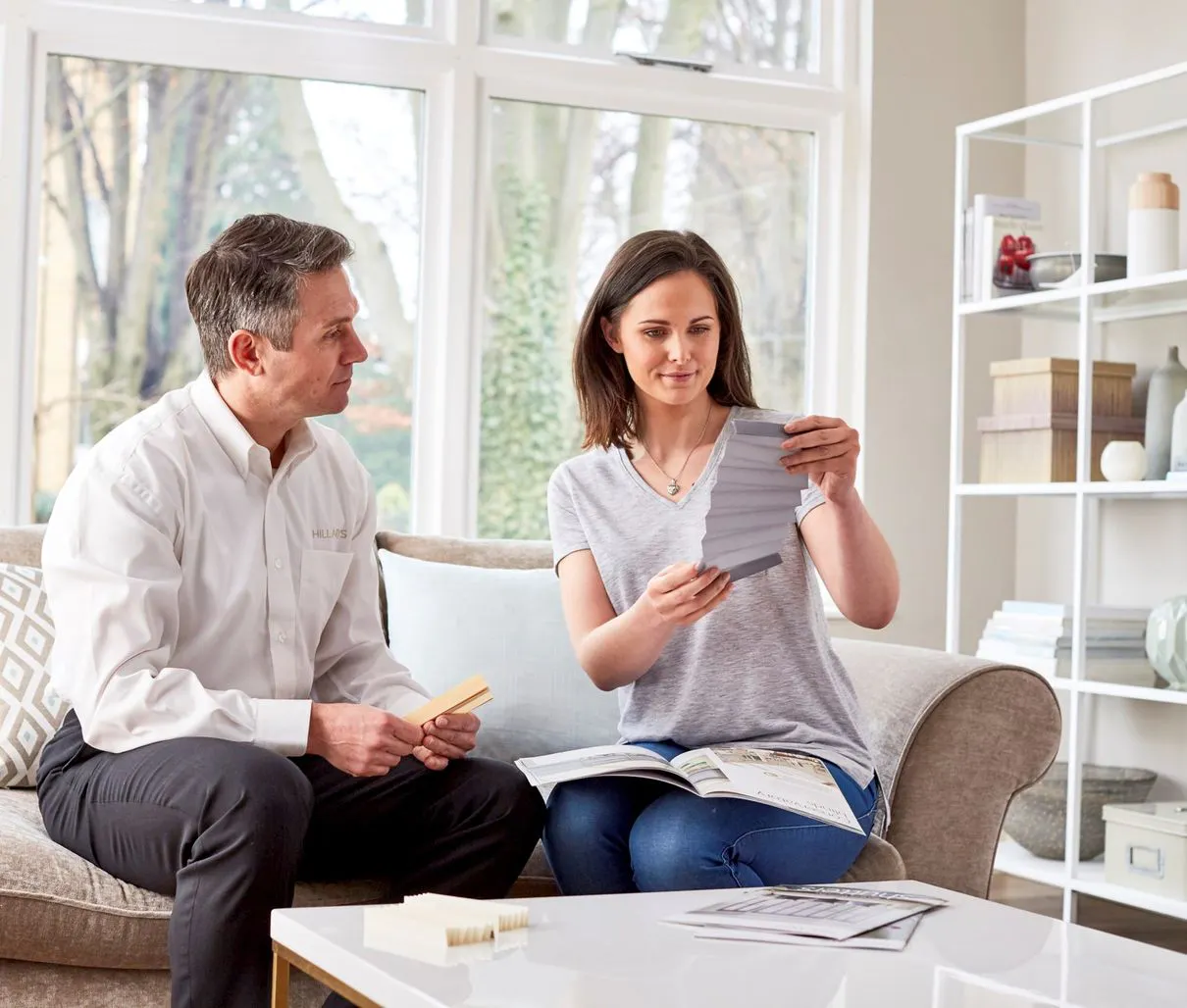 Hillarys advisor and customer looking at samples during an appointment at customer's home