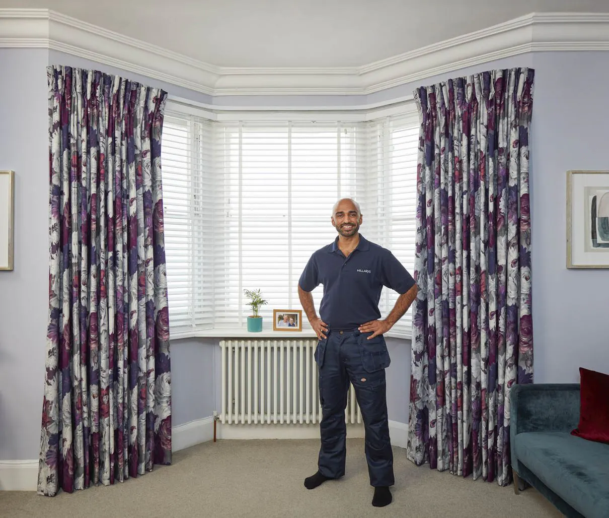 Hillarys advisor confidently standing in front of a window in customer's home 