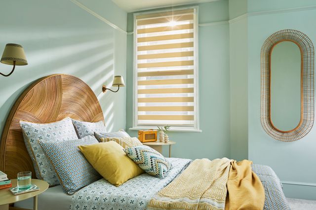 A light pastel bedroom with beige Day and Night blinds on a standard window. 