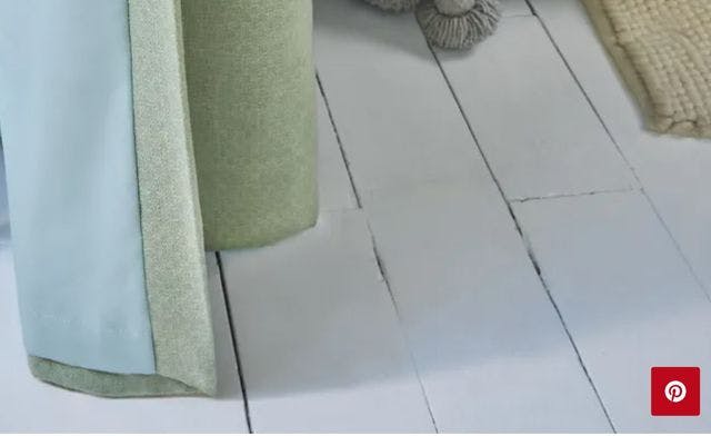 Close up of light green curtains with a coloured light blue lining