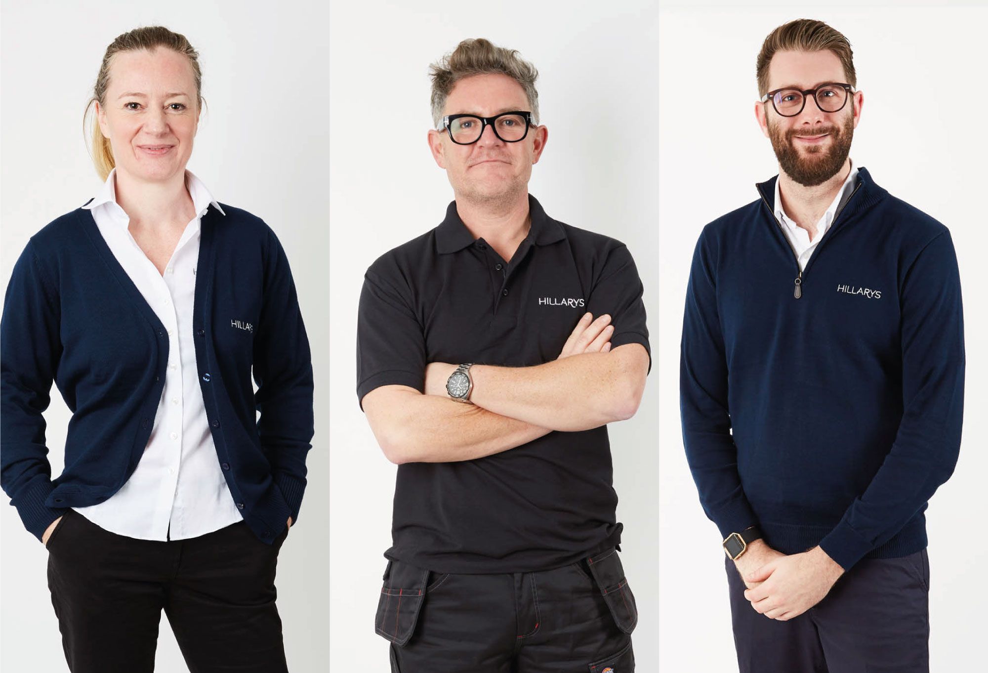 Three Hillarys advisors wearing branded navy uniforms, standing side‑by‑side against a white studio backdrop.