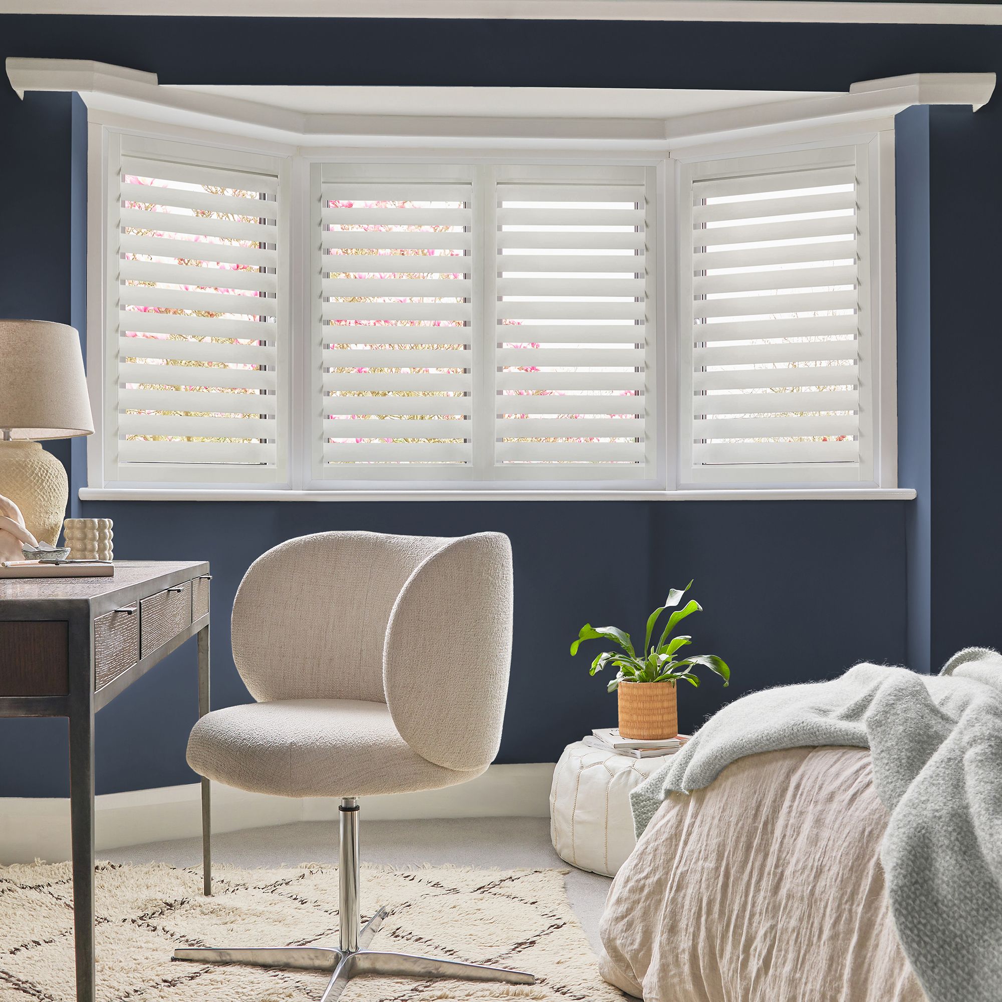 Perfect Fit lace-white shutters installed flush to the glazing, louvers partially open in a bright minimalist room.