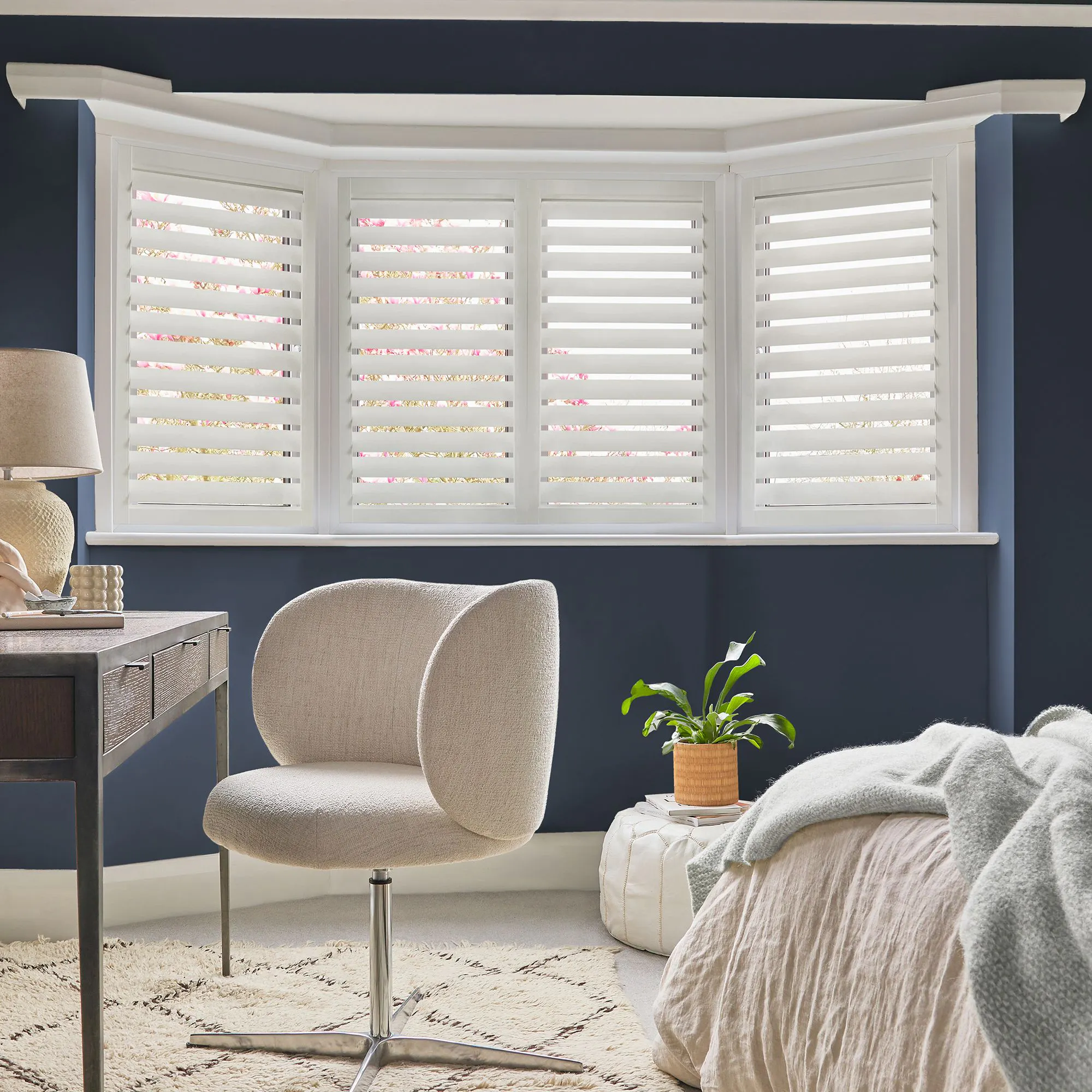 Perfect Fit lace-white shutters installed flush to the glazing, louvers partially open in a bright minimalist room.