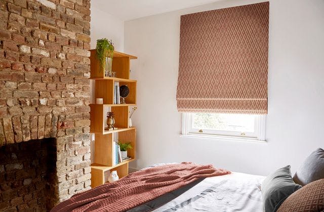 Modern light bedroom with orange  Geometric blinds on a standard window