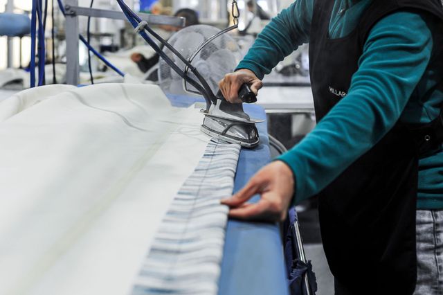 Hillarys staff ironing curtains in the factory  