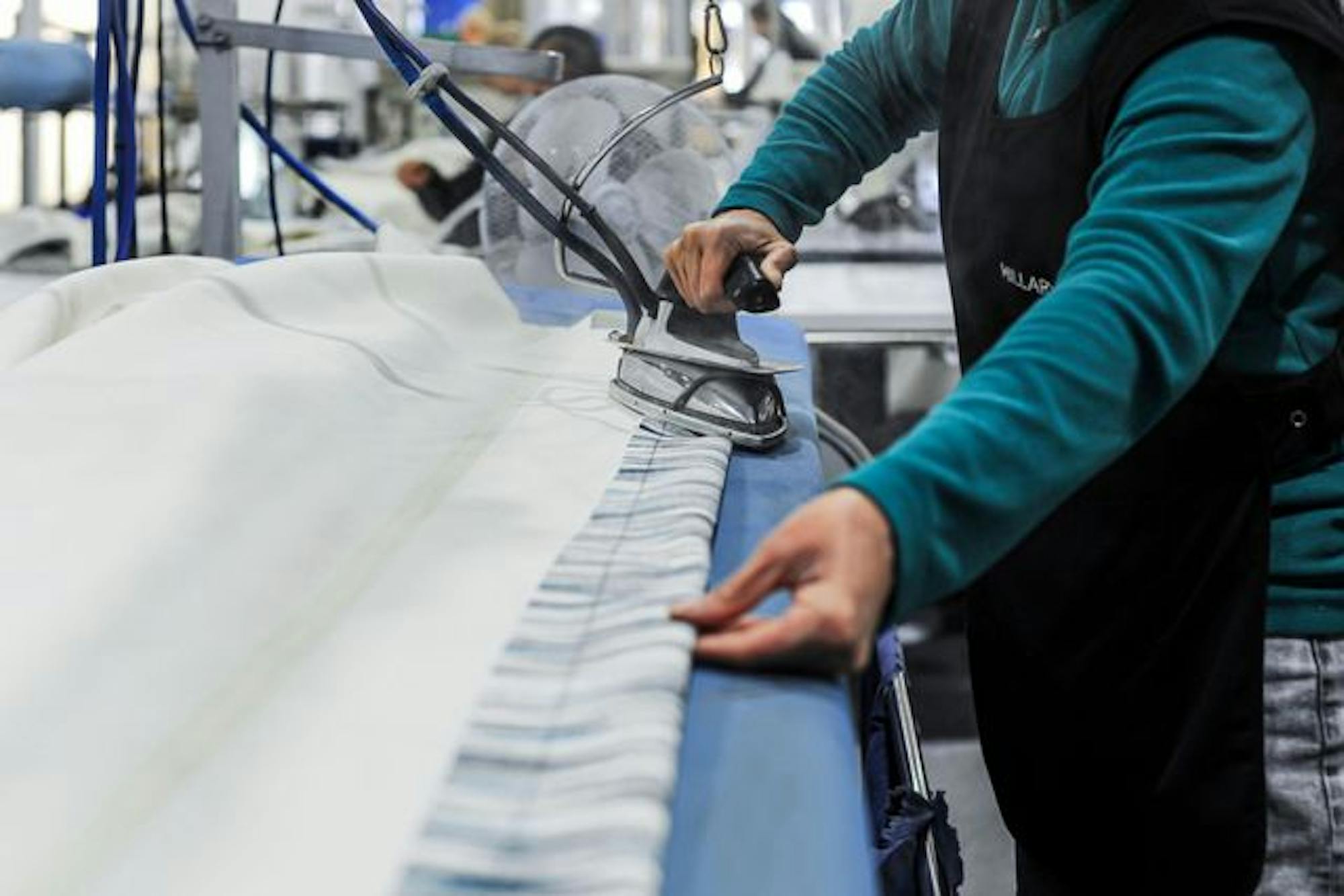 Hillarys staff ironing curtains in the factory