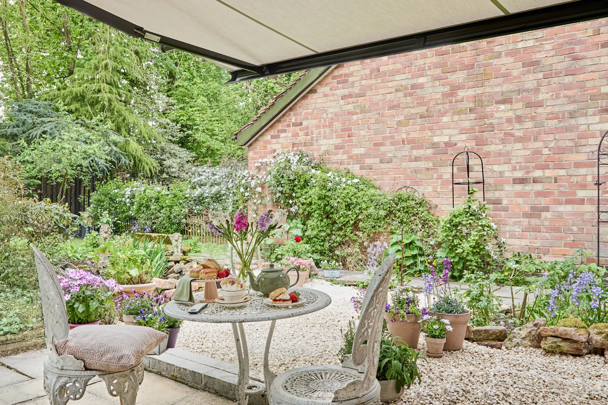 Cream Awning located in the garden alongside a garden table