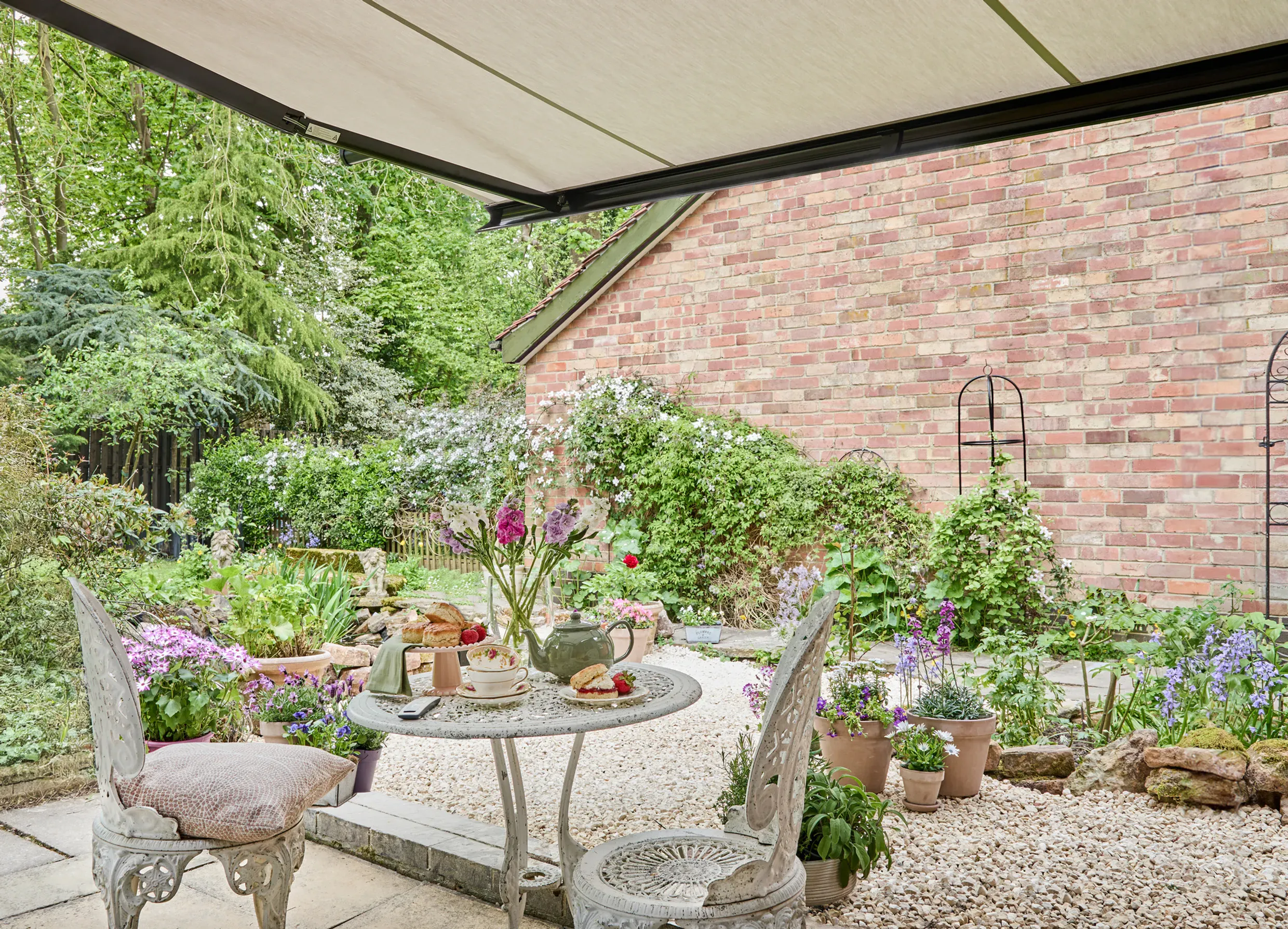 Cream Awning located in the garden alongside a garden table