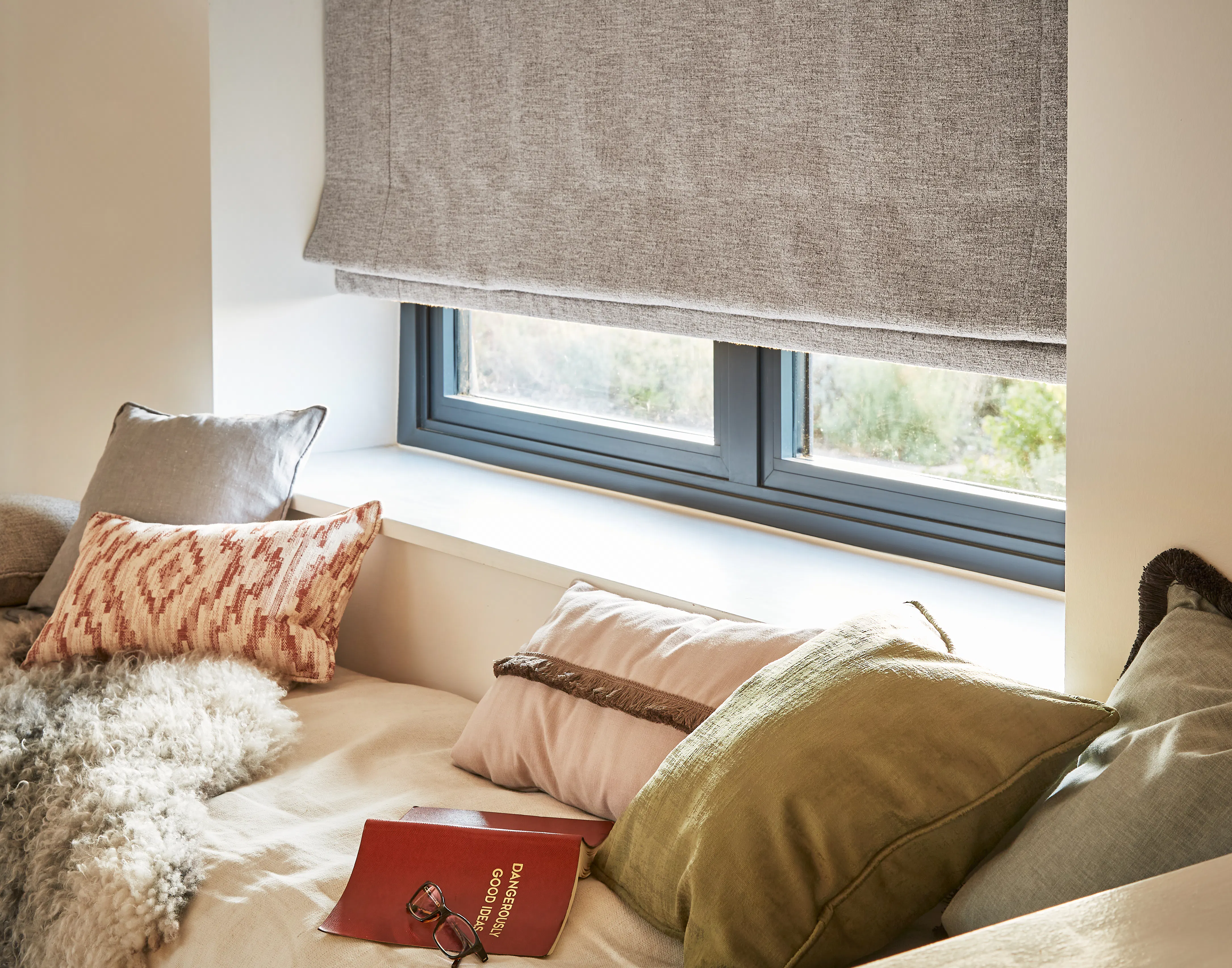 Nest pewter roman blind covering cosy living room