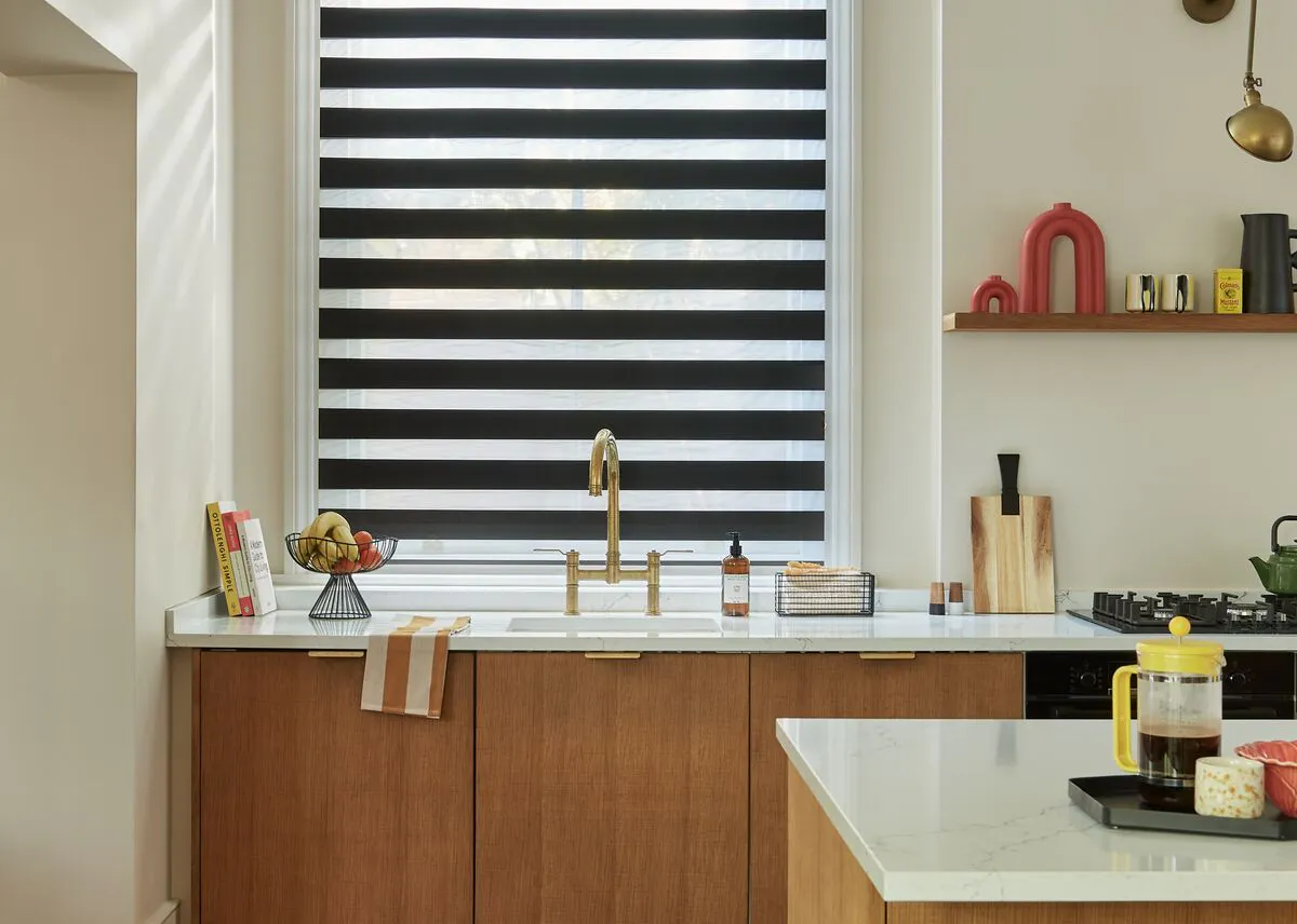 Lark Black Day and Night blinds on a window in a cosy kitchen