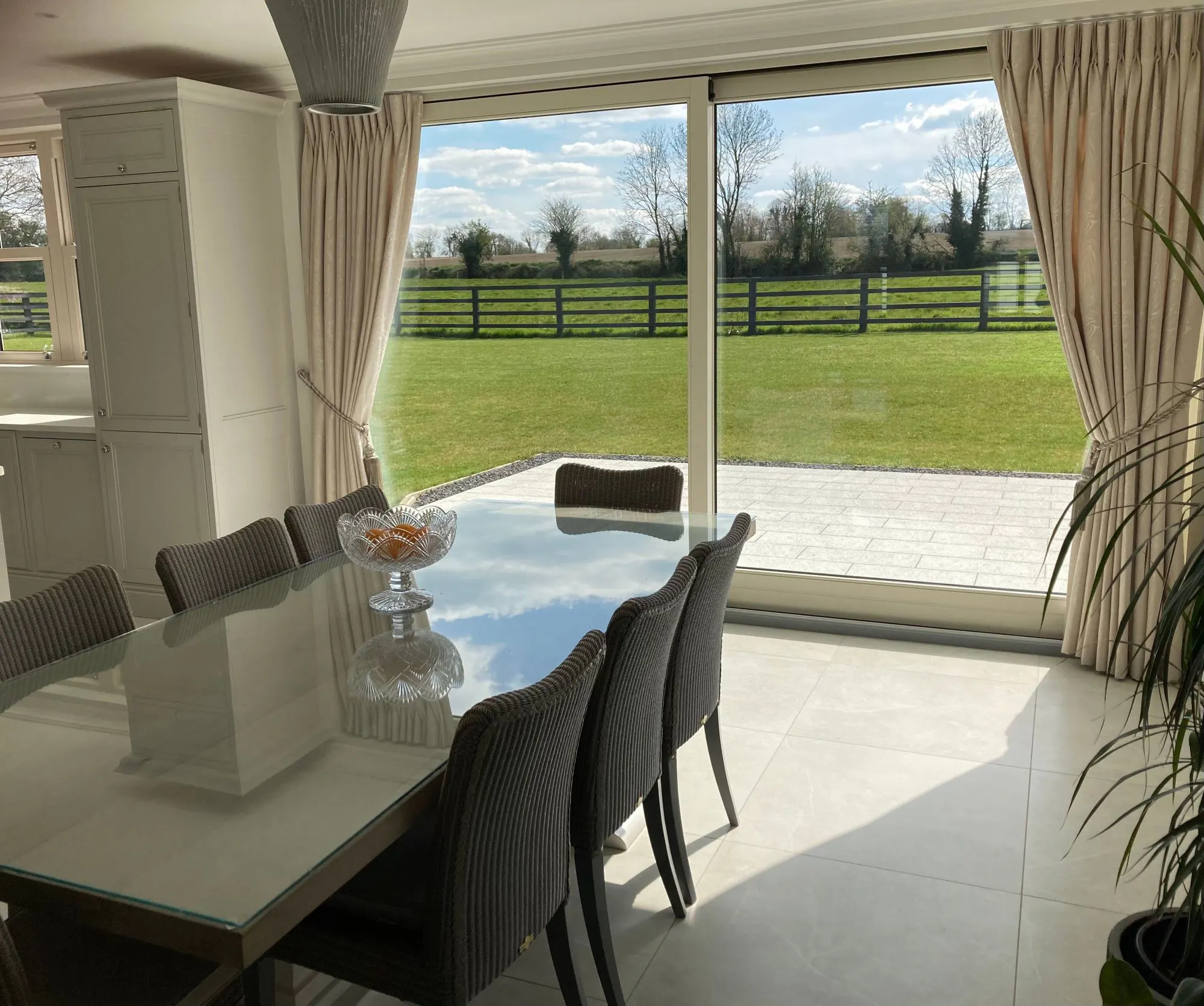 Cream pinch pleat curtains in a modern dining room