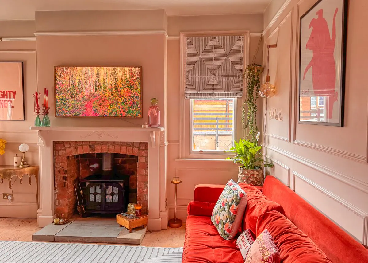 A cosy living room featuring two windows dressed with Roman blinds, filling the space with soft light.