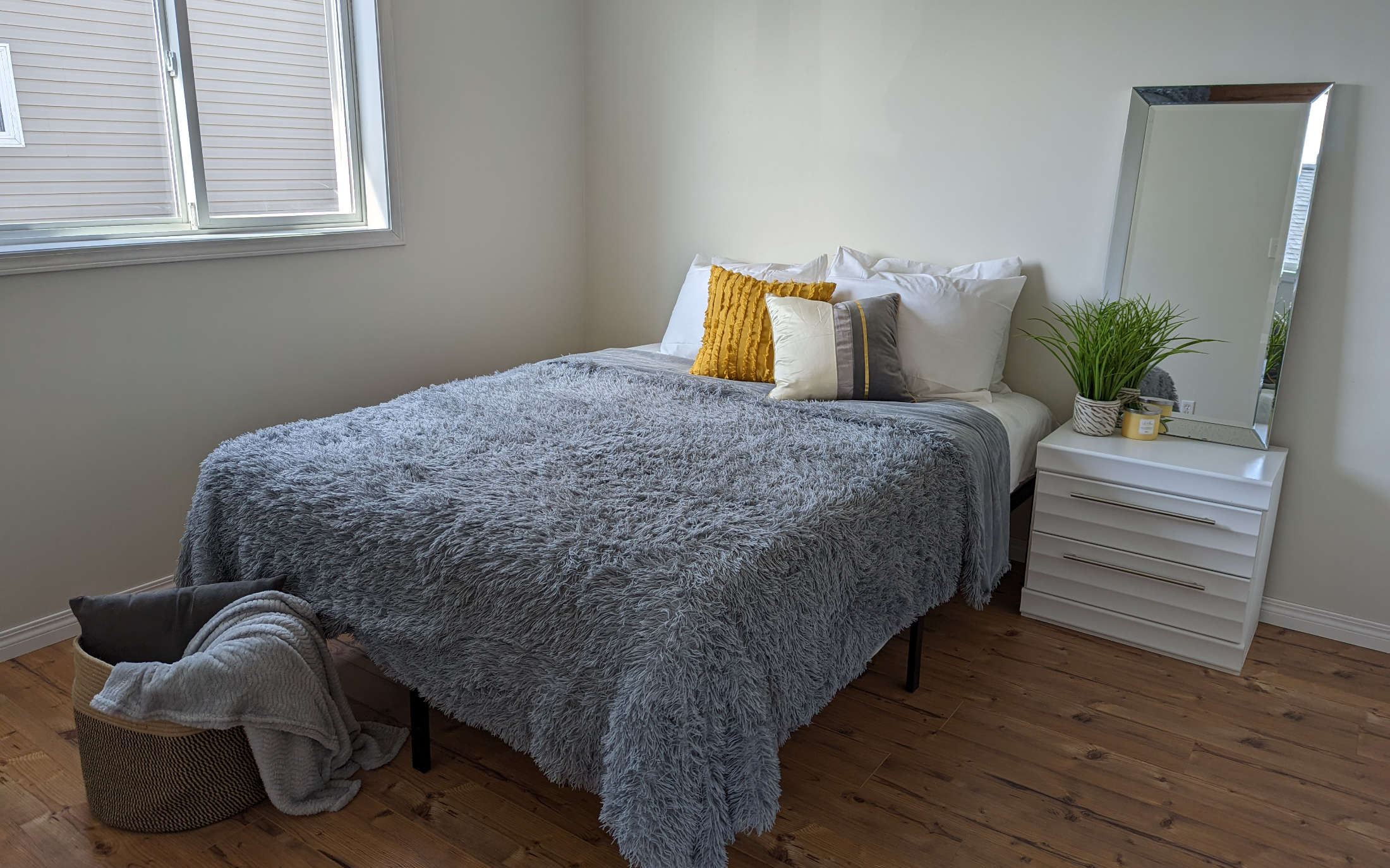 Staged bedroom with plush pillows and bedding - Hint of Honey