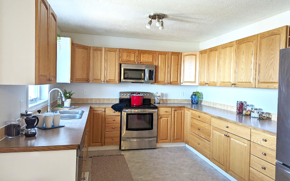 Staged kitchen with pleasing accessories and accents - Hint of Honey Fort St John