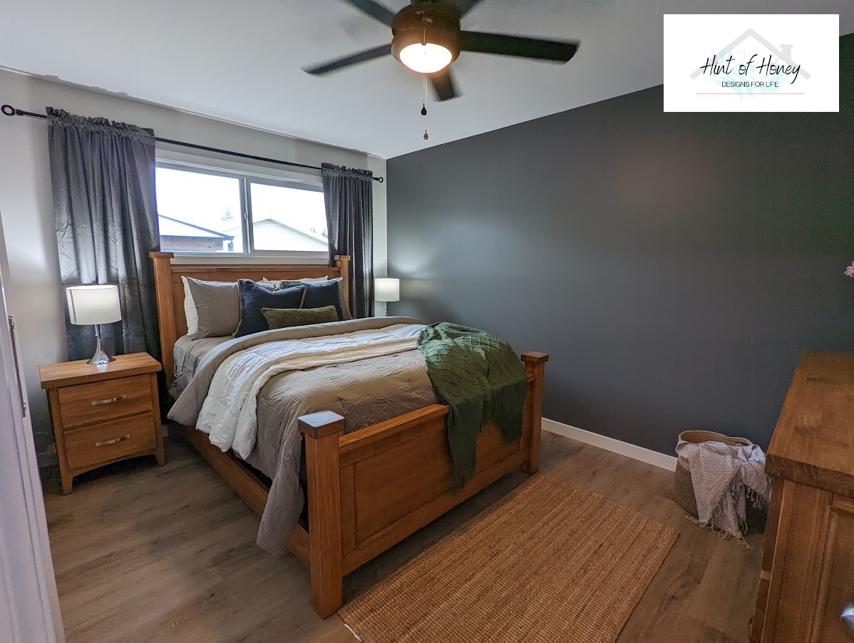 Bedroom with rustic wood bedframe and bright accents, designed by Hint of Honey