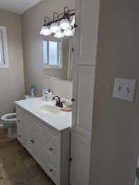 Bathroom with white cabinetry before renovation by Hint of Honey