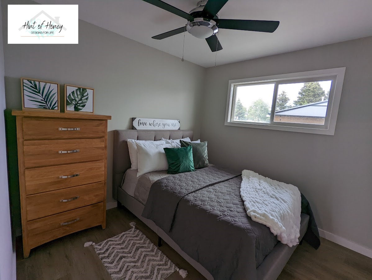 Staged bedroom with plush throw pillows and modern art, home staging by Hint of Honey