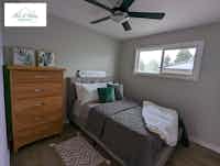 Staged bedroom with plush throw pillows and modern art, home staging by Hint of Honey