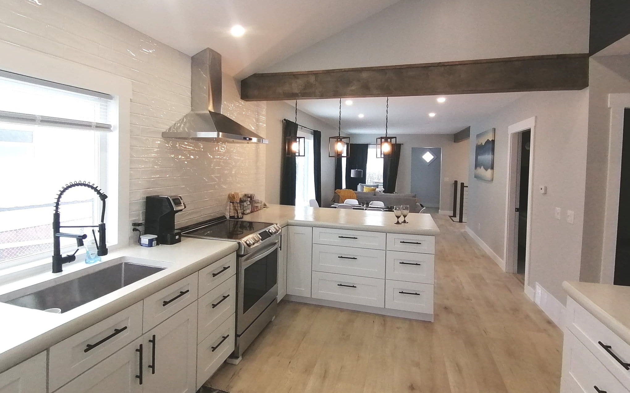 Modern kitchen with white cupboards and stainless appliances - Hint of Honey