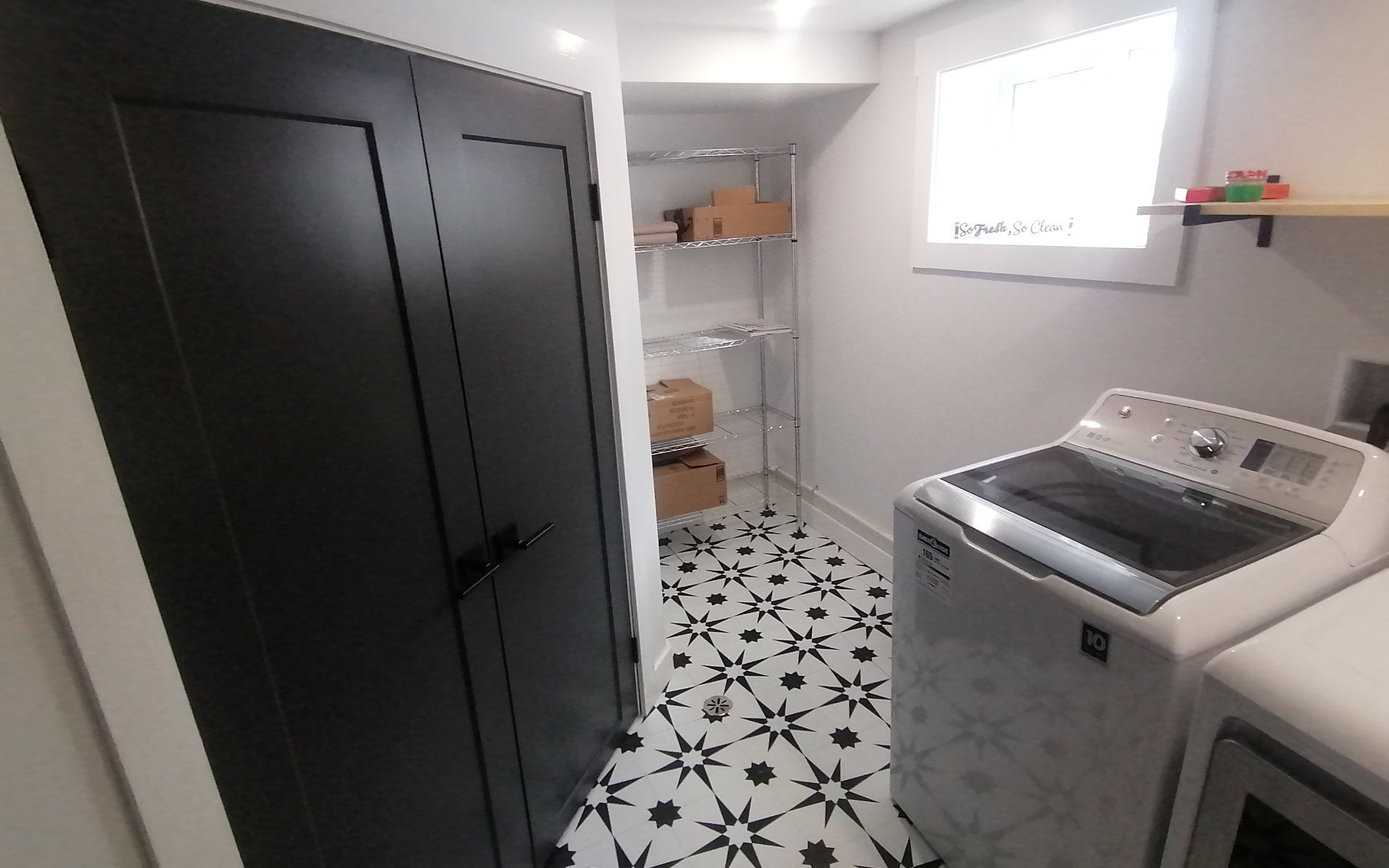 Designer laundry room with new appliances and sleek black doors - Hint of Honey