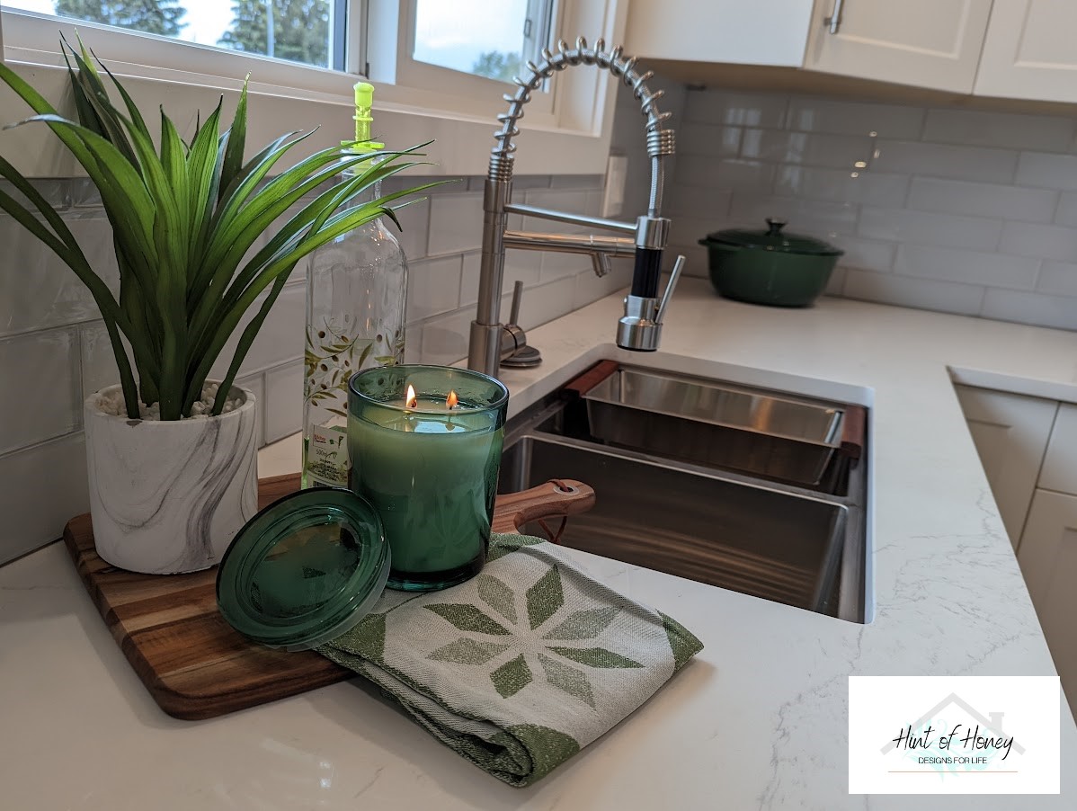 Staged kitchen with candles and green plants, home staging by Hint of Honey