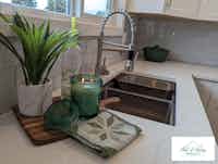 Staged kitchen with candles and green plants, home staging by Hint of Honey