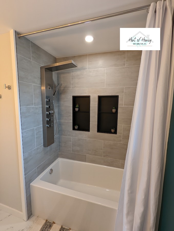 Bathroom with tiled in bathtub and custom shower head, designed by Hint of Honey