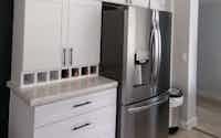 Stainless fridge with white cupboards in modern kitchen - Hint of Honey