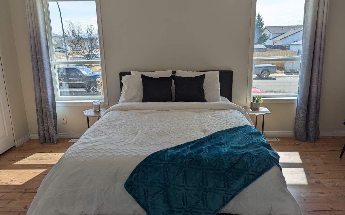 Home staging in Fort St John, modern and inviting master bedroom staged by Hint of Honey