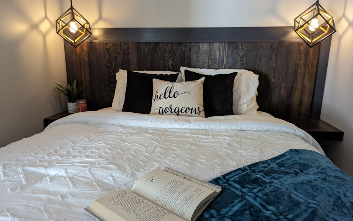 Modern bedroom design - wood bed frame with chic lighting - Hint of Honey