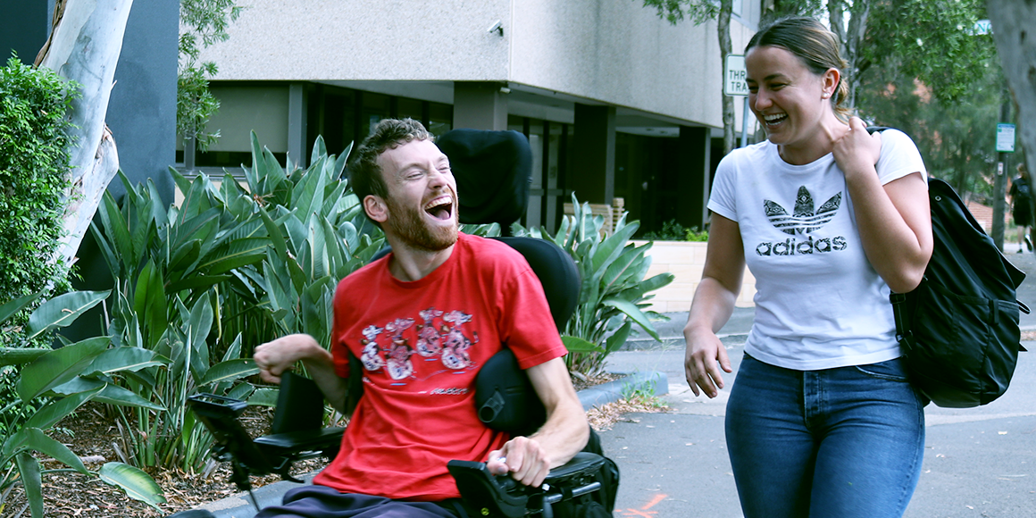 Hireup user Nick laughing with his disability support worker Tessa. 