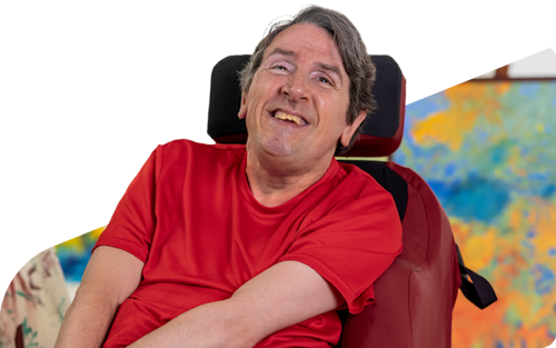 Hireup user Glenn smiles at the camera.