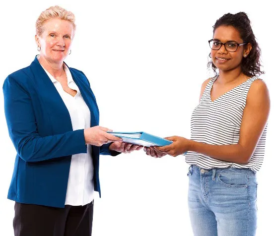 A woman shares documents with another woman.
