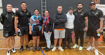 Kurranulla Aboriginal Corporation NDIS youth group clients pose in a line, smiling, facing the camera.
