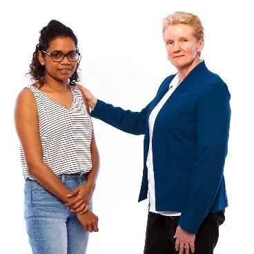 A woman with her hand on the shoulder of another woman.