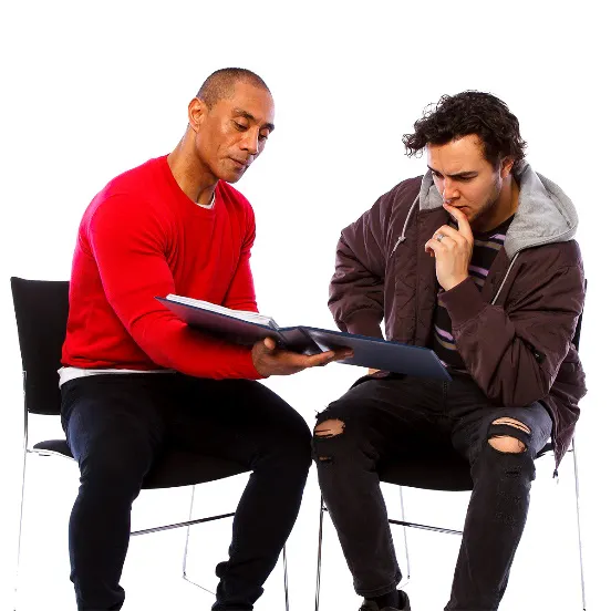 Two men looking at a document together