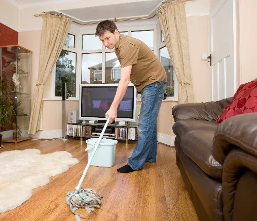 A man mopping a floor at home