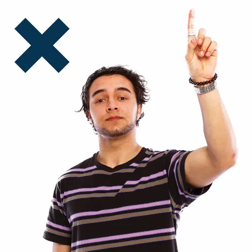 A man raising his hand to say something with a cross next to him
