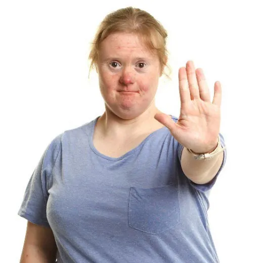 A woman with her hand up to say, "Stop"