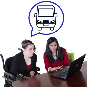 A person helps a woman at a computer. The woman has decided something.