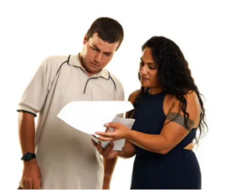 One person helping another to read a document