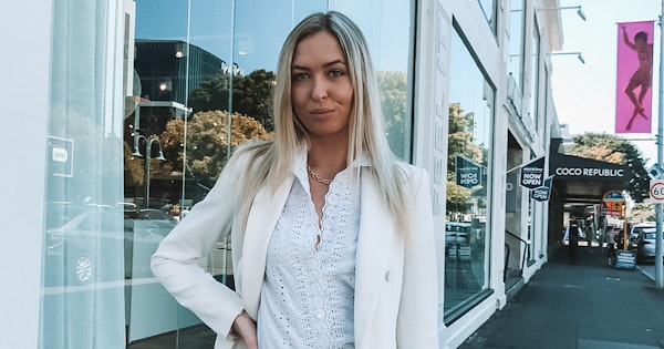 Disability advocate and Champion Health Agency founder, Anja Christoffersen, stands on a city street.