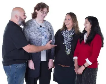 A group of people smiling and talking.