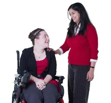 A woman with her hand on the shoulder of a woman with disability.