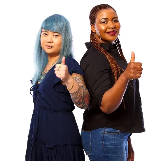 2 women smiling with thumbs up