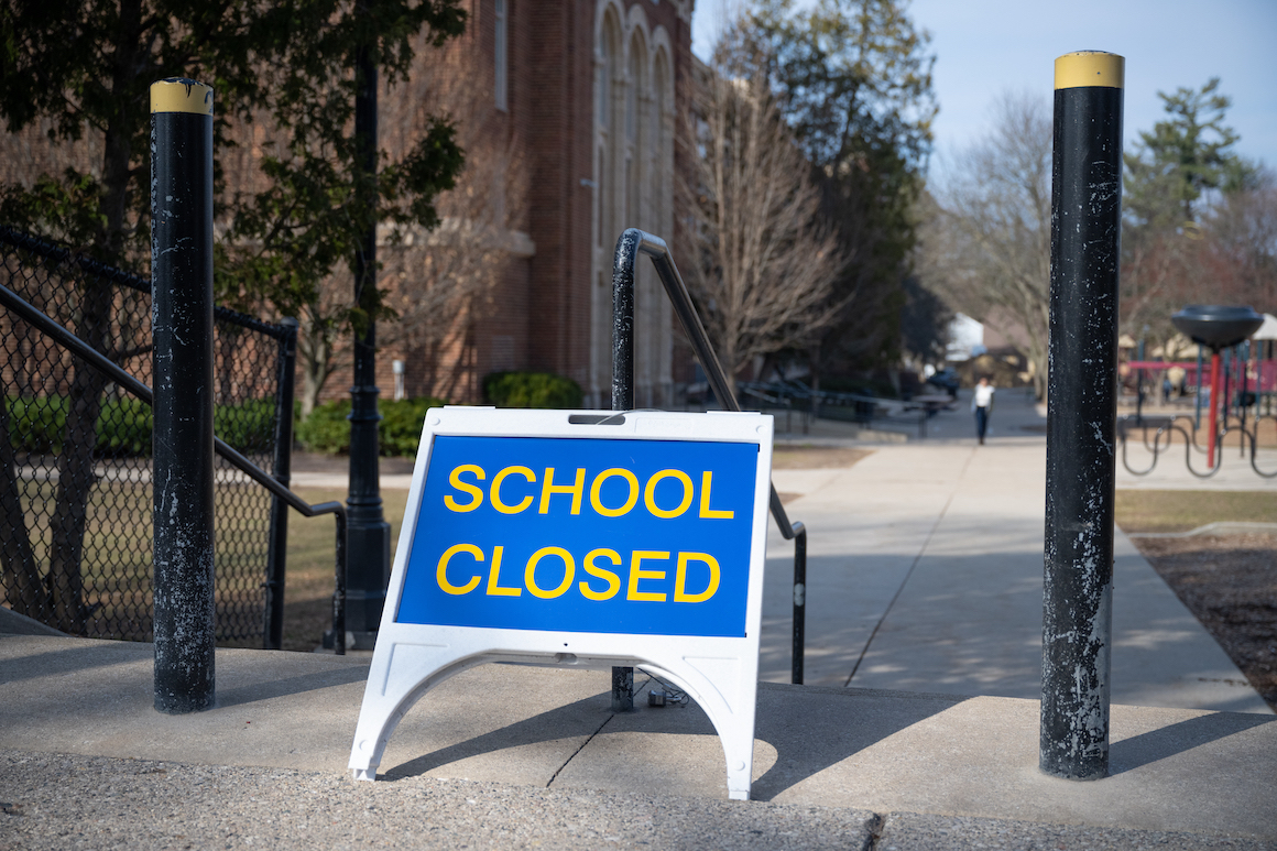 Image shows a sign reading "School Closed" is positioned outside a school. Photo credit: Ayman Haykal. 