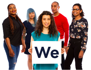A group of people. There is a woman at the front of the group, she is holding a card that says "we".