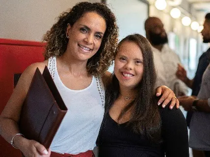 Two women standing together smiling