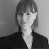 A black and white profile image of Briana. Briana has short straight hair and is wearing a black top.